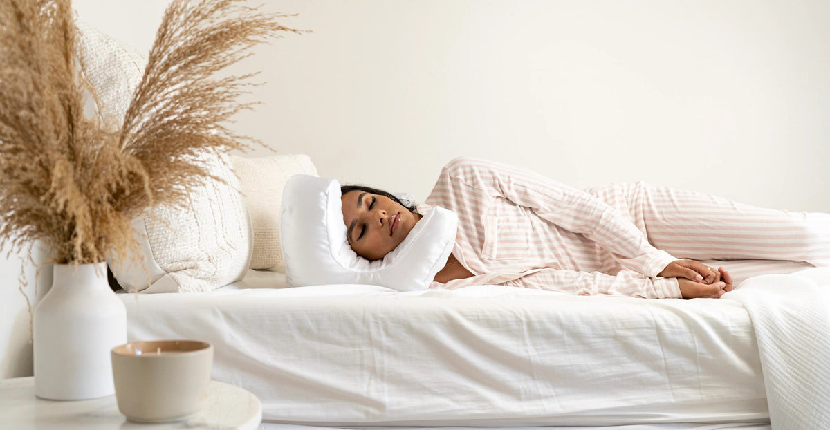Woman sleeping on her side with her cheek resting in the Flawless Face Pillow cut-out
